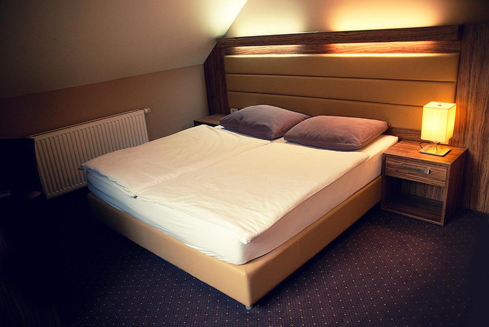 Postel nebo postele na pokoji v ubytování Hotel Opara