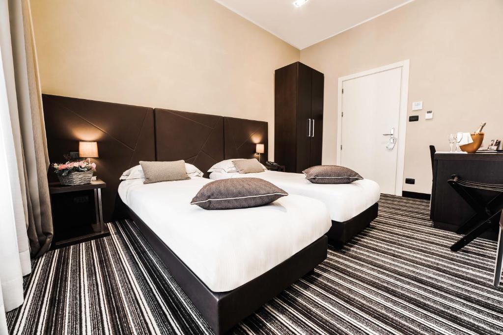 Postel nebo postele na pokoji v ubytování Hotel Principe Di Torino