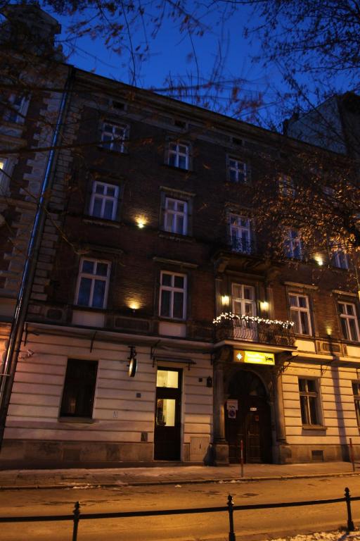a large brick building at night with lights at Ventus Rosa Apartments in Krakow