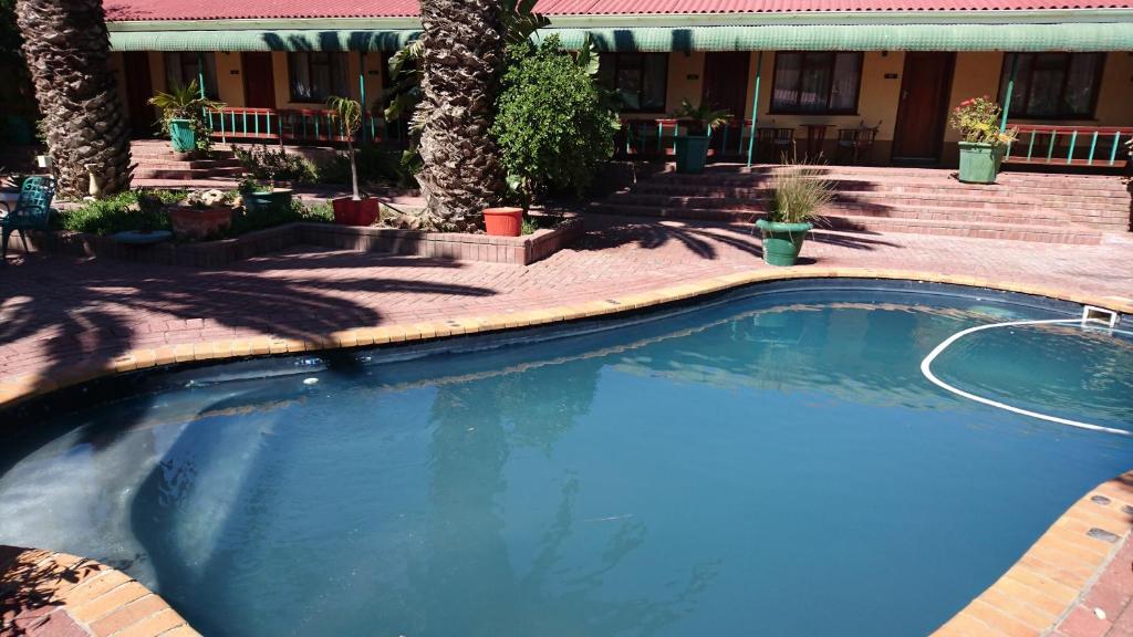 a large swimming pool in front of a house at Lamberts Bay Hotel in Lambertʼs Bay