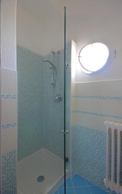 a bathroom with a shower with a glass door at Iris Hotel in Ischia
