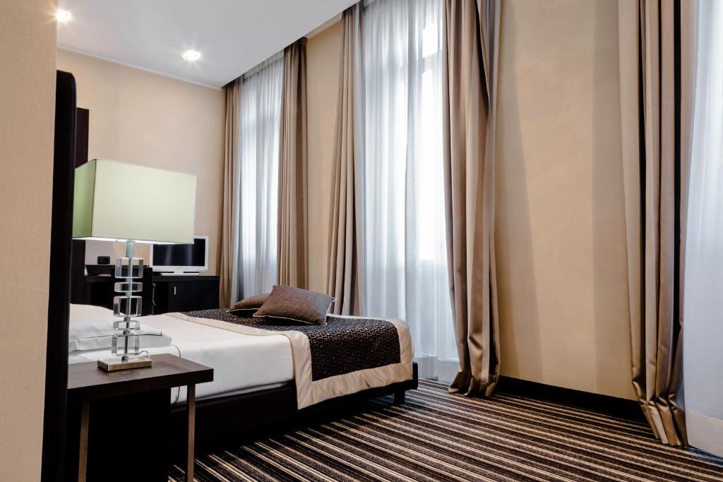 Postel nebo postele na pokoji v ubytování Hotel Principe Di Torino