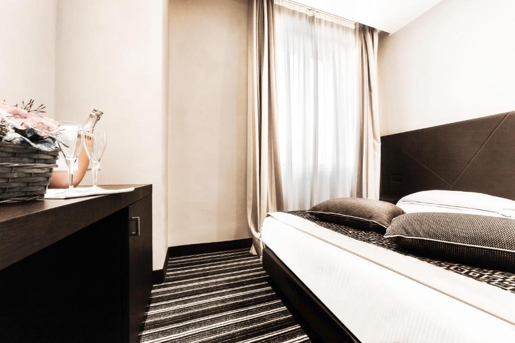 Postel nebo postele na pokoji v ubytování Hotel Principe Di Torino