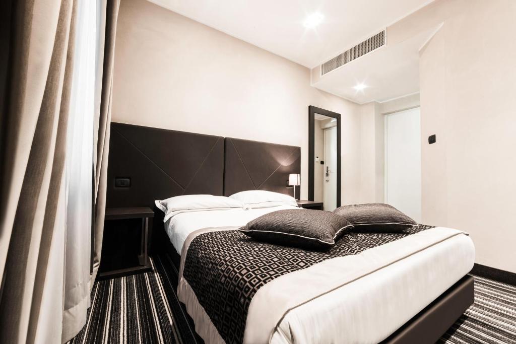 Postel nebo postele na pokoji v ubytování Hotel Principe Di Torino