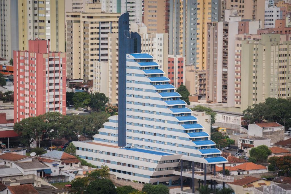 a large building with blue roofs in a city at Blue Tree Premium Londrina in Londrina