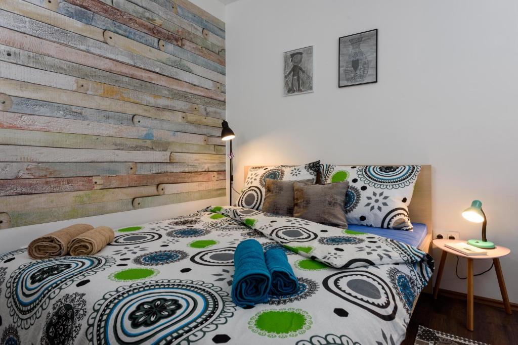 a bedroom with a bed with a wooden accent wall at Apartment Danijela in Trogir