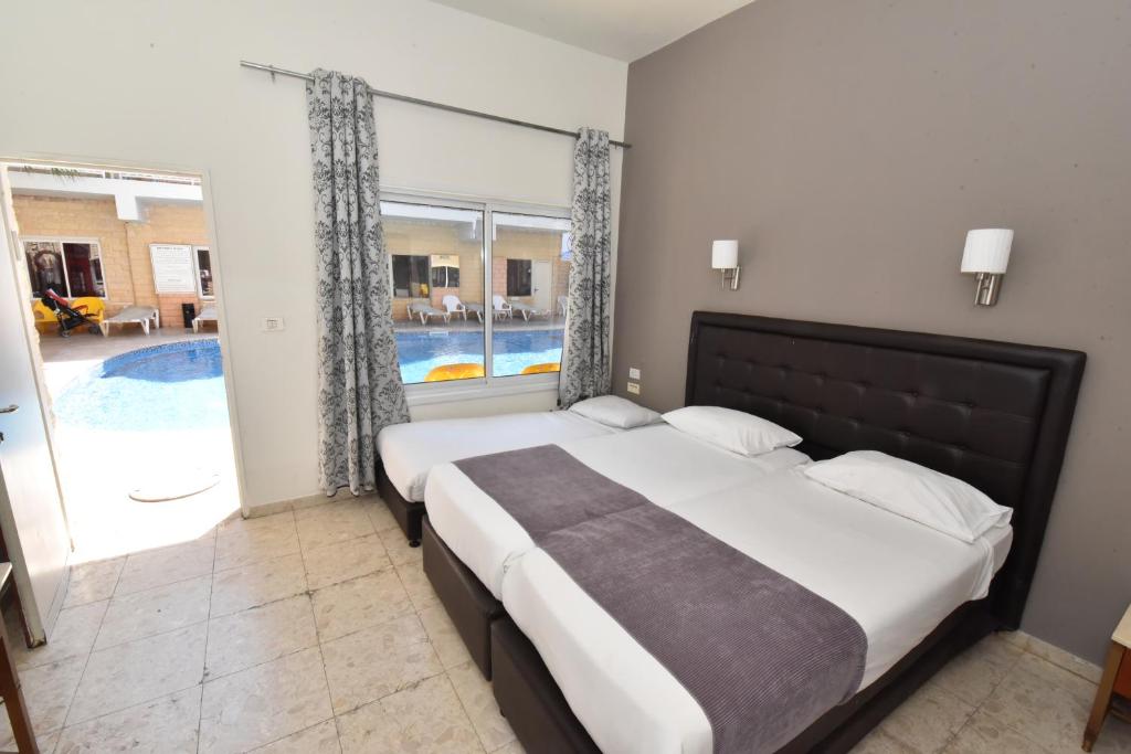 Postel nebo postele na pokoji v ubytování Hotel Maman