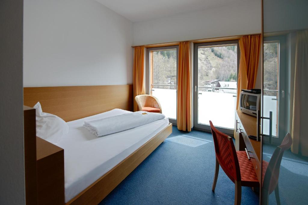Postel nebo postele na pokoji v ubytování Hotel Garni Sunshine