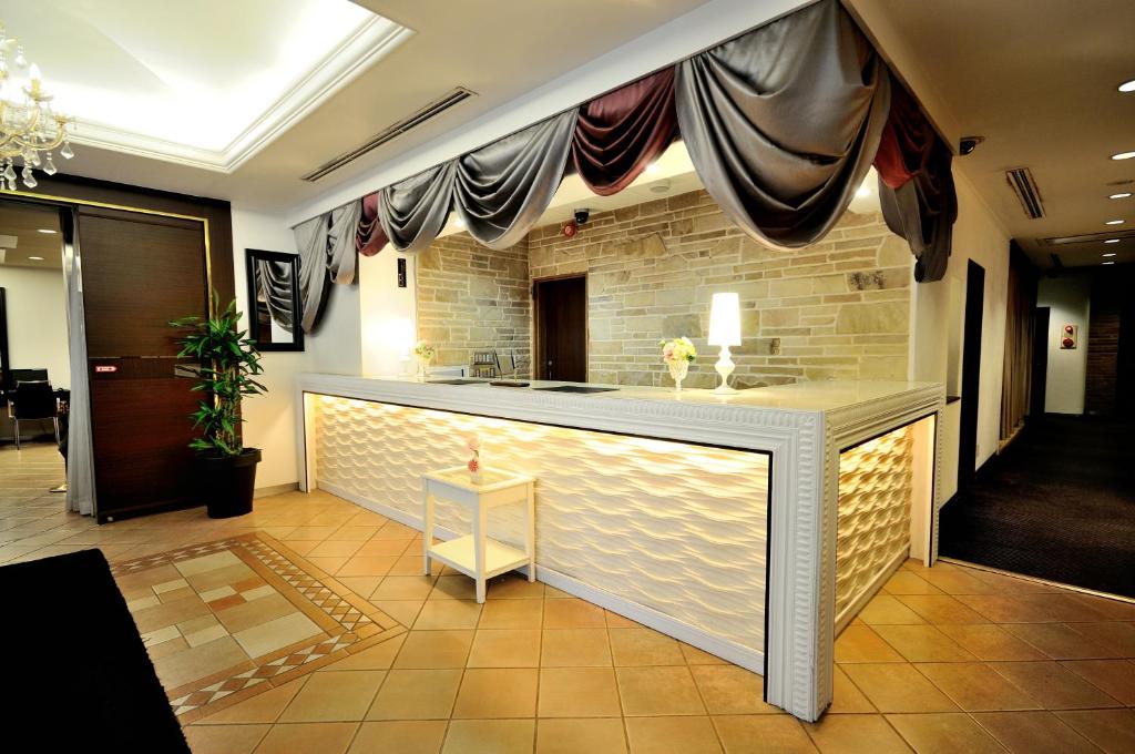 a bar in a lobby with a stone wall at Grand Park Hotel Panex Tokyo in Tokyo