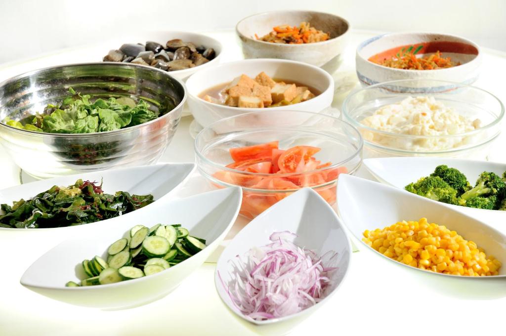a group of bowls filled with different types of vegetables at Grand Park Hotel Panex Tokyo in Tokyo