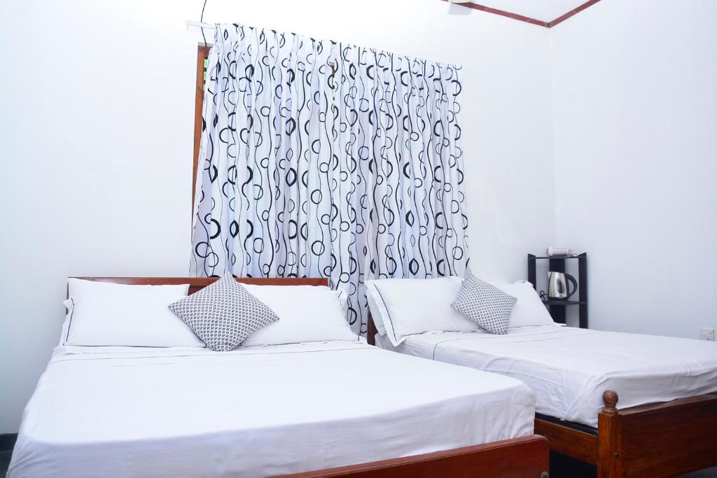 Postel nebo postele na pokoji v ubytování Livinginn Polonnaruwa