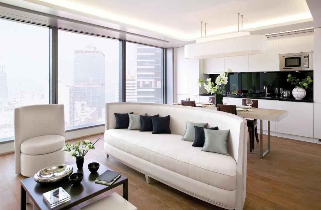 a living room with a white couch and a table at The Putman in Hong Kong