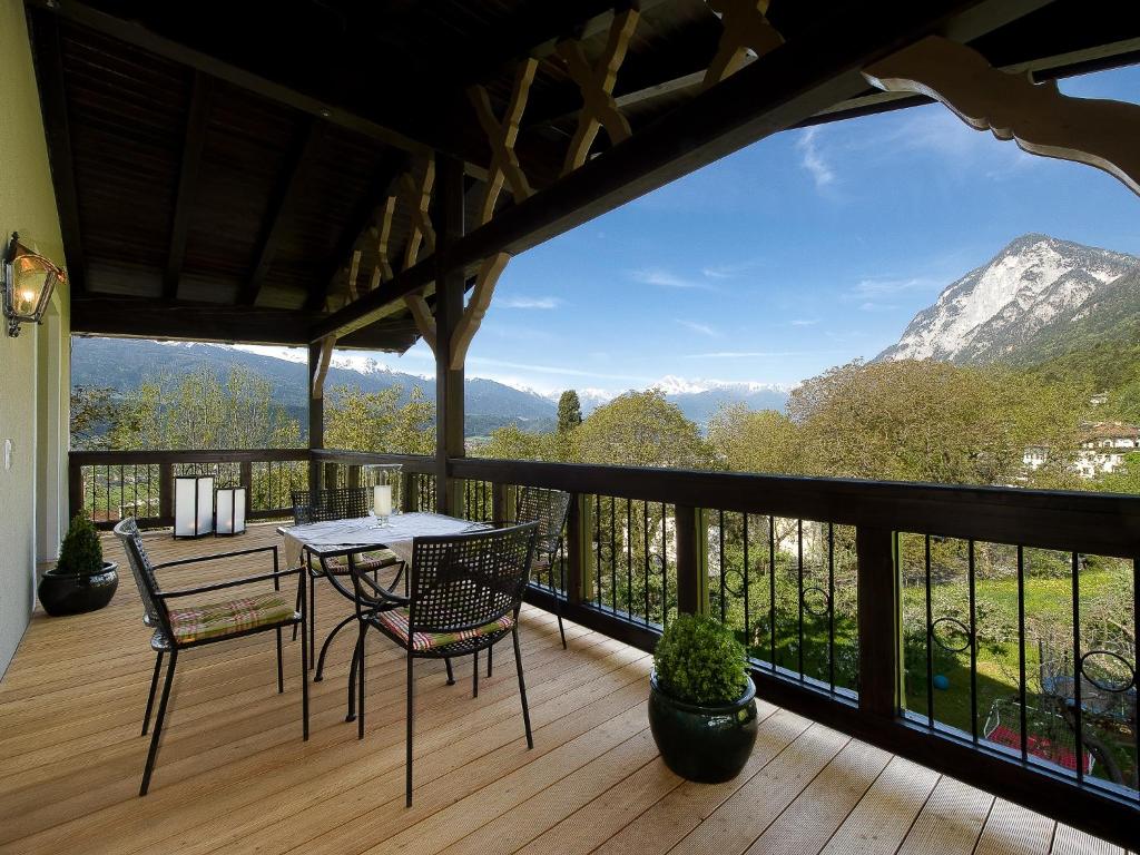 a patio with a table and chairs on a deck at Kasperhof Apartments Innsbruck Top 6 - 7 in Innsbruck