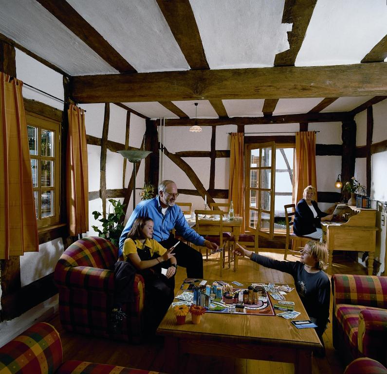 a group of people sitting in a living room at Historische Wassermühle in Birgel