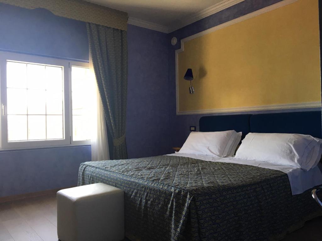 Postel nebo postele na pokoji v ubytování Grand Hotel Cesenatico
