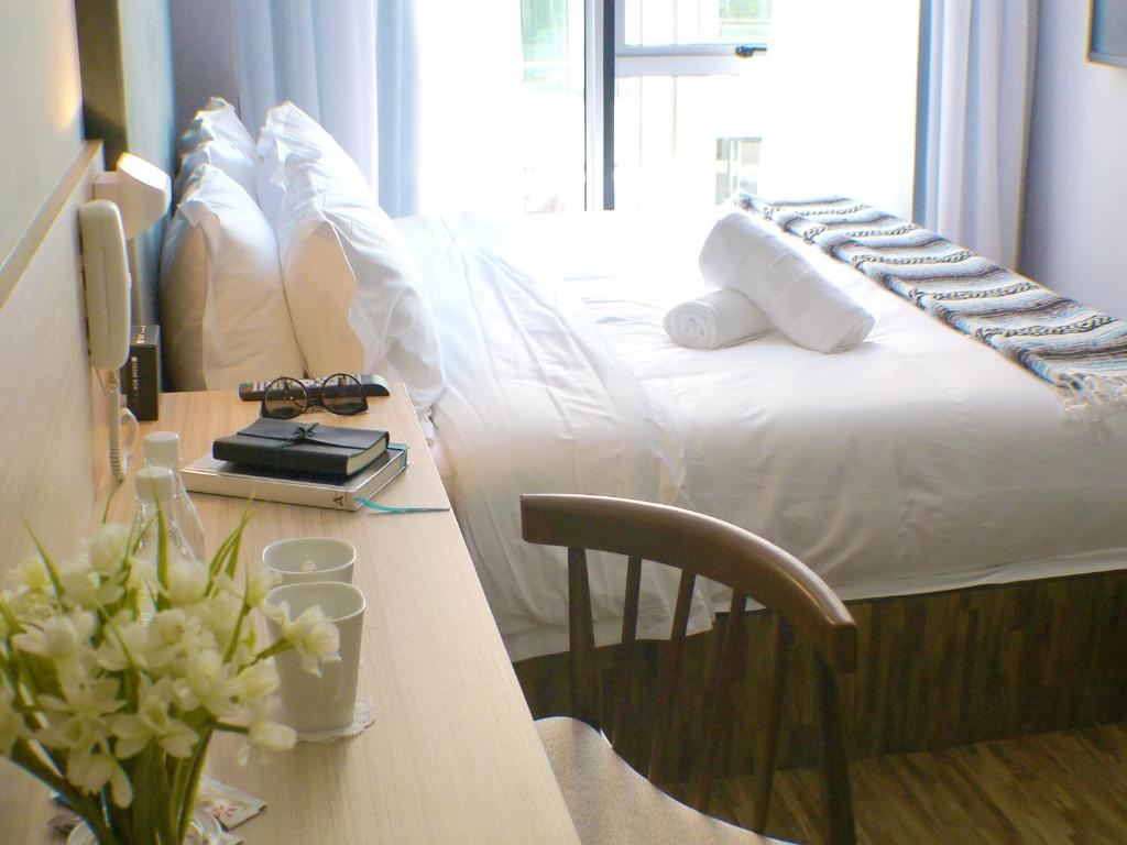 a hotel room with a bed and a desk at Hako Hotel in Skudai
