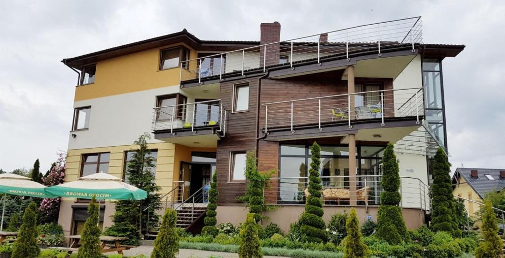 an apartment building with balconies and a patio at Czarna Perła in Ostrowo