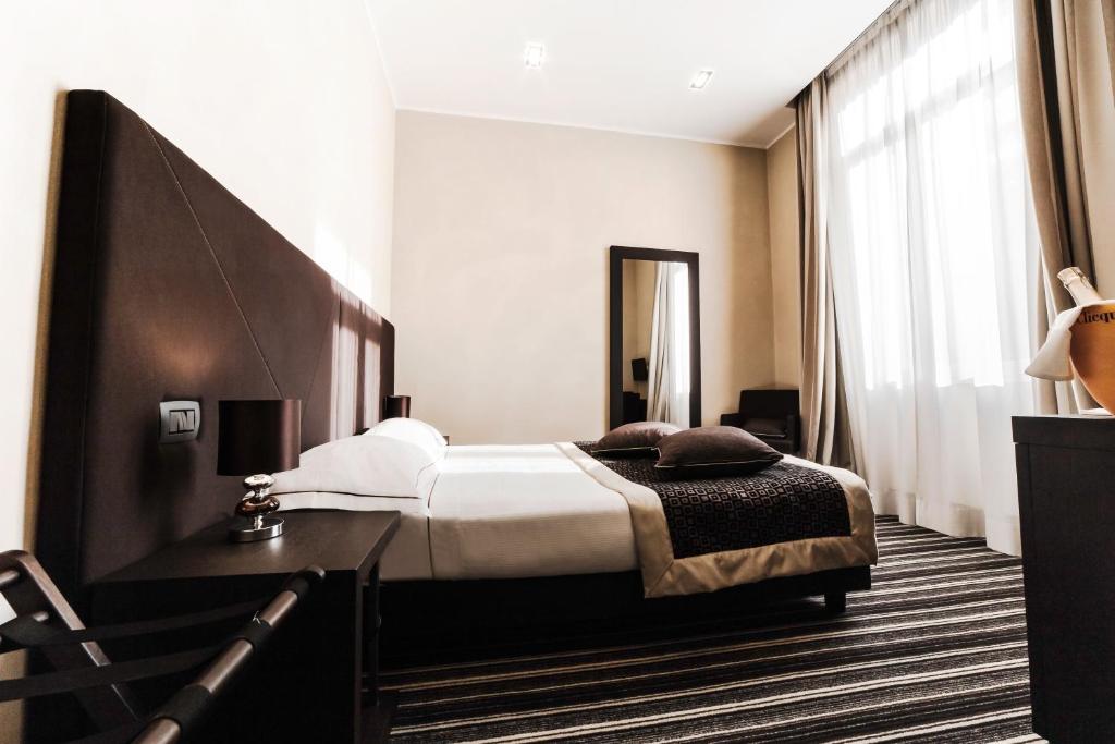Postel nebo postele na pokoji v ubytování Hotel Principe Di Torino