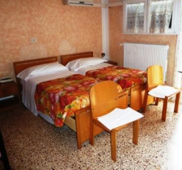 Postel nebo postele na pokoji v ubytování Hotel Bolognese