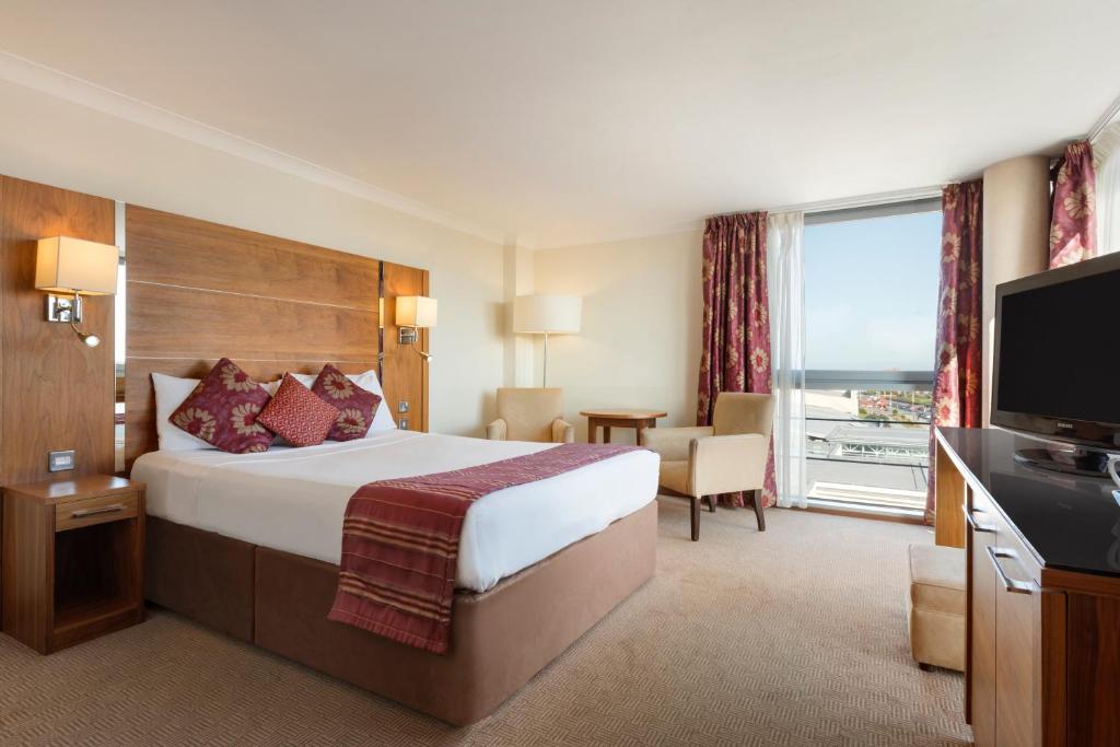 a hotel room with a bed and a television at Waterfront Southport Hotel in Southport