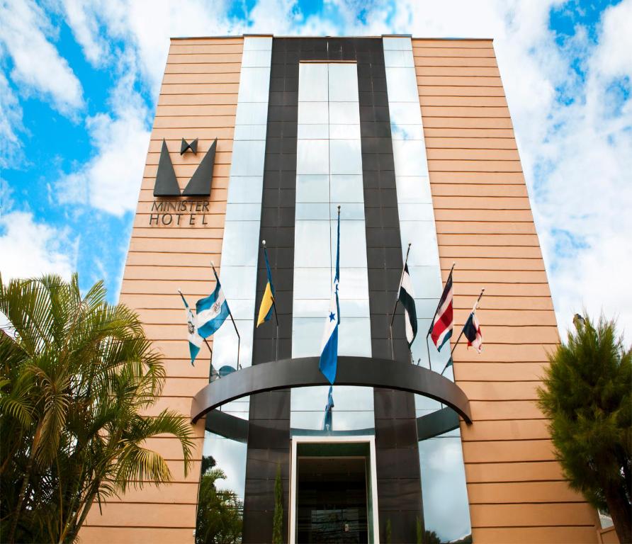 a hotel with flags in front of a building at Minister Business Hotel in Tegucigalpa