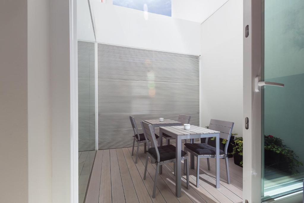 a dining room with a table and chairs on a balcony at Faro Boutique Hotel in Faro