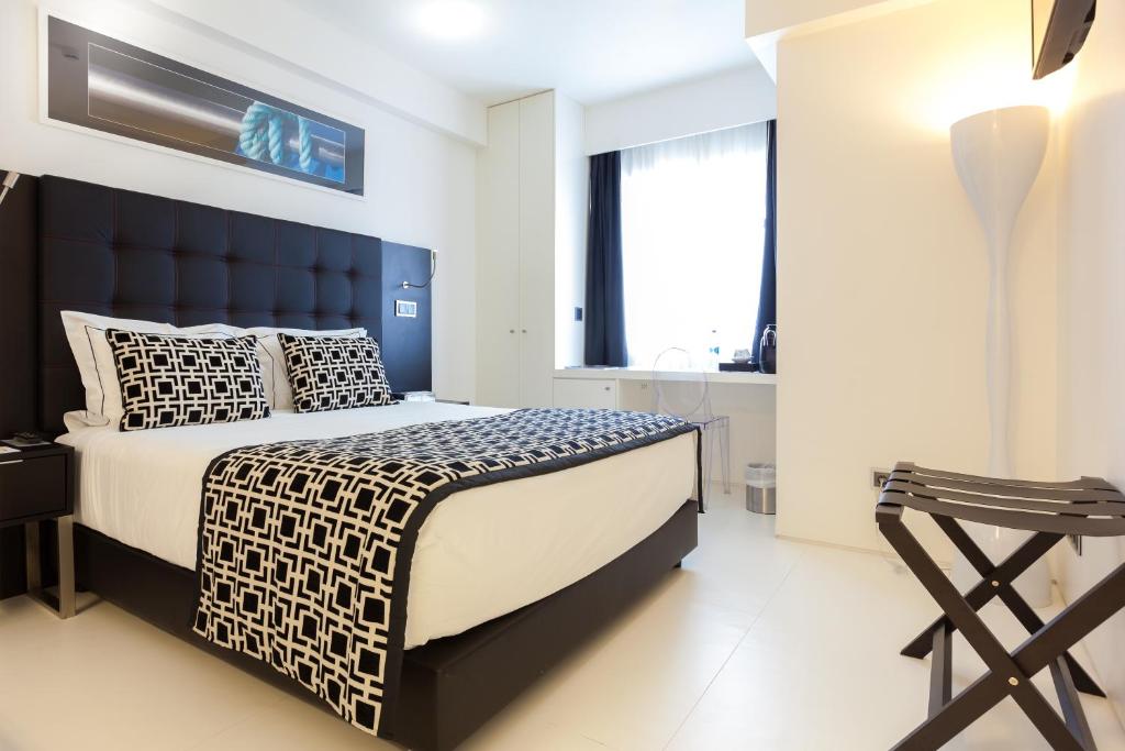 a bedroom with a large bed with a blue headboard at Faro Boutique Hotel in Faro