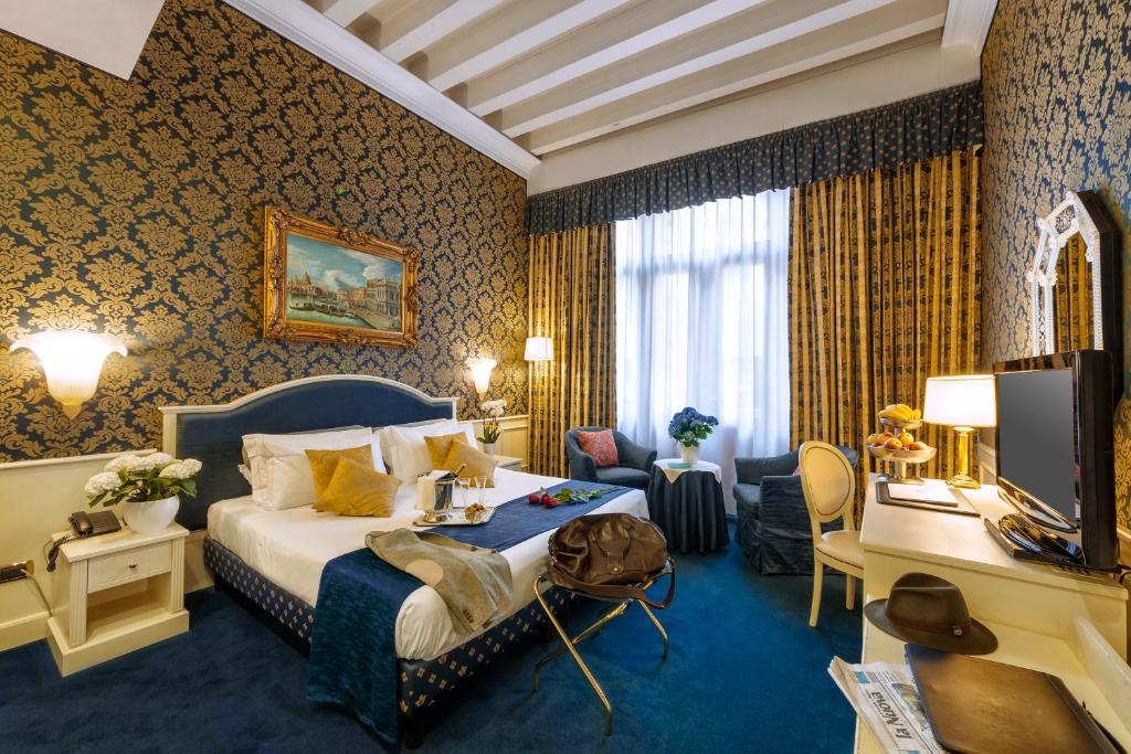 a hotel room with a bed and a desk at Duodo Palace in Venice