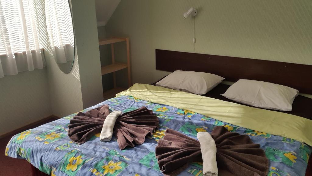 a bedroom with a bed with towels on it at Terve Hostel in Pärnu