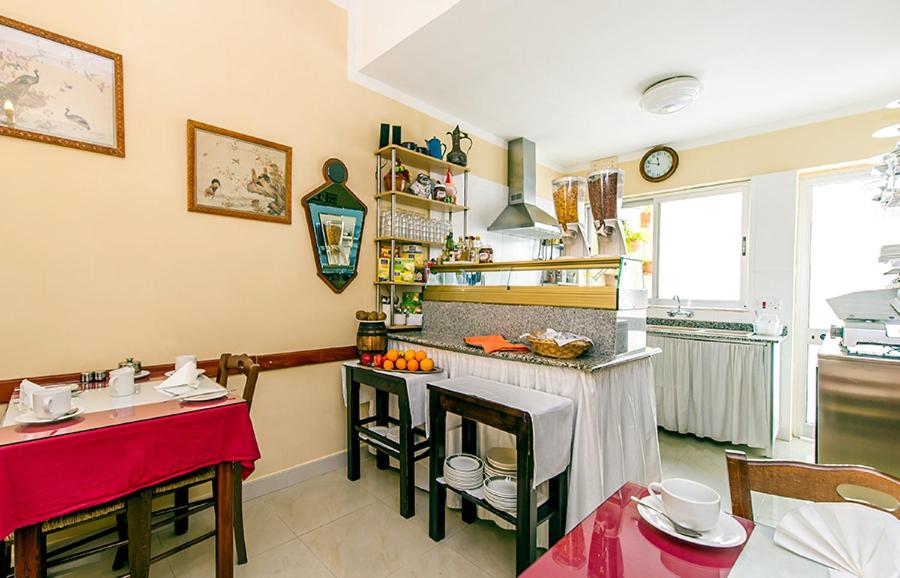a kitchen with a counter and a table in a room at Lantern Guest House in Marsalforn