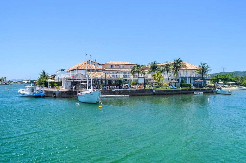 a group of boats docked at a dock in the water at Residencial Portoveleiro in Cabo Frio