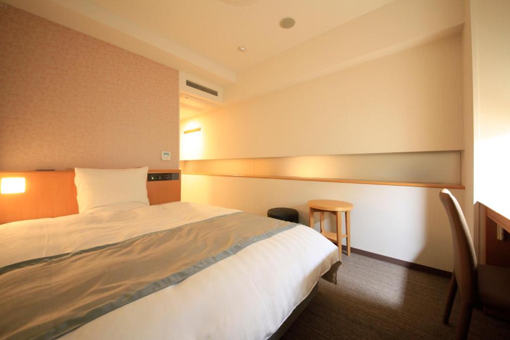 Tempat tidur dalam kamar di Richmond Hotel Sapporo Ekimae