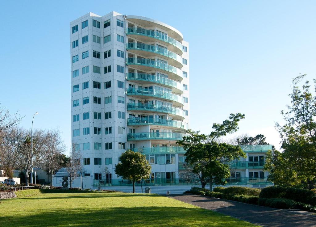 a tall white building with a park in front of it at Top Of The Town Bed & Breakfast in Tauranga