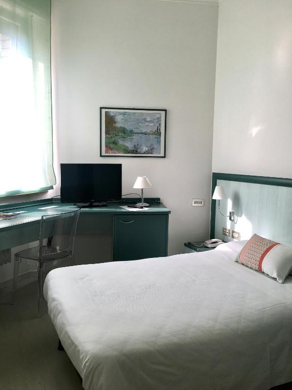 Postel nebo postele na pokoji v ubytování Hotel Europa