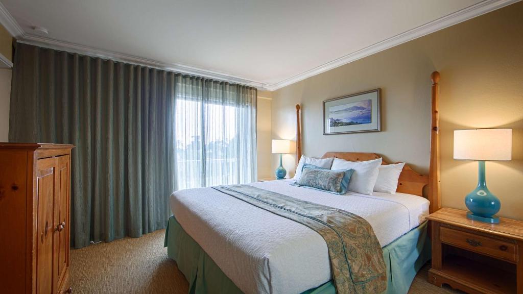 a bedroom with a large bed and a large window at Carmel Bay View Inn in Carmel