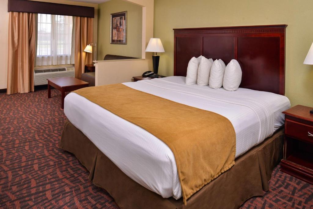 a large hotel room with a large bed and a desk at Best Western Eunice in Eunice