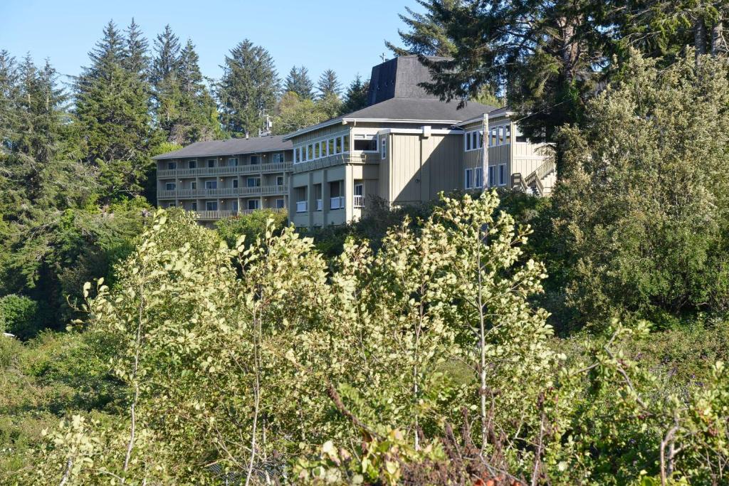 a building on top of a hill with trees at Best Western Pier Point Inn in Florence