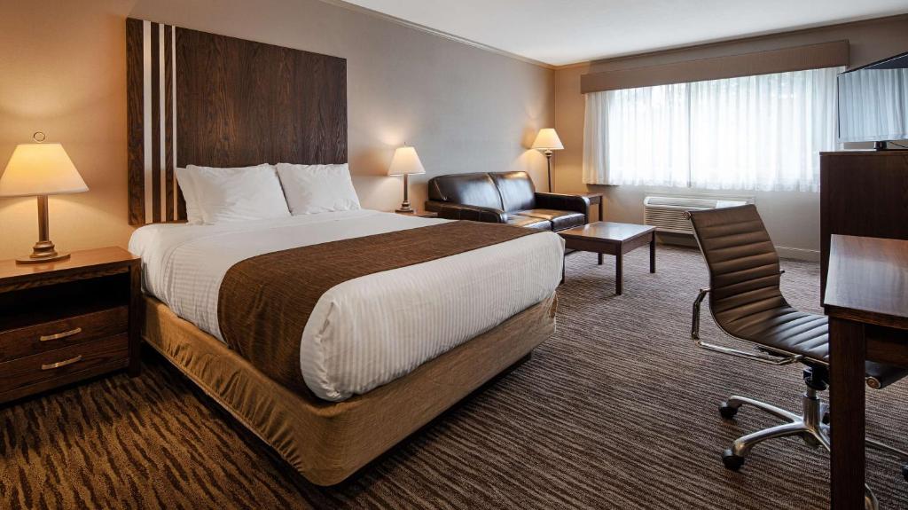 a hotel room with a bed and a chair at Best Western Mountainview Inn in Golden