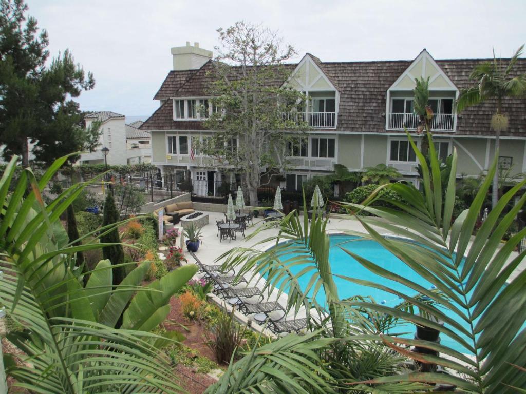 a large house with a swimming pool in front of it at Best Western Premier Hotel Del Mar in San Diego