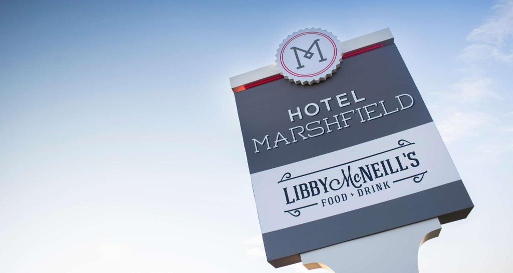 a sign for a hotel with a clock on it at Hotel Marshfield, BW Premier Collection in Marshfield