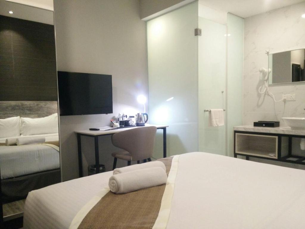 Postel nebo postele na pokoji v ubytování The Leverage Business hotel (Skudai)