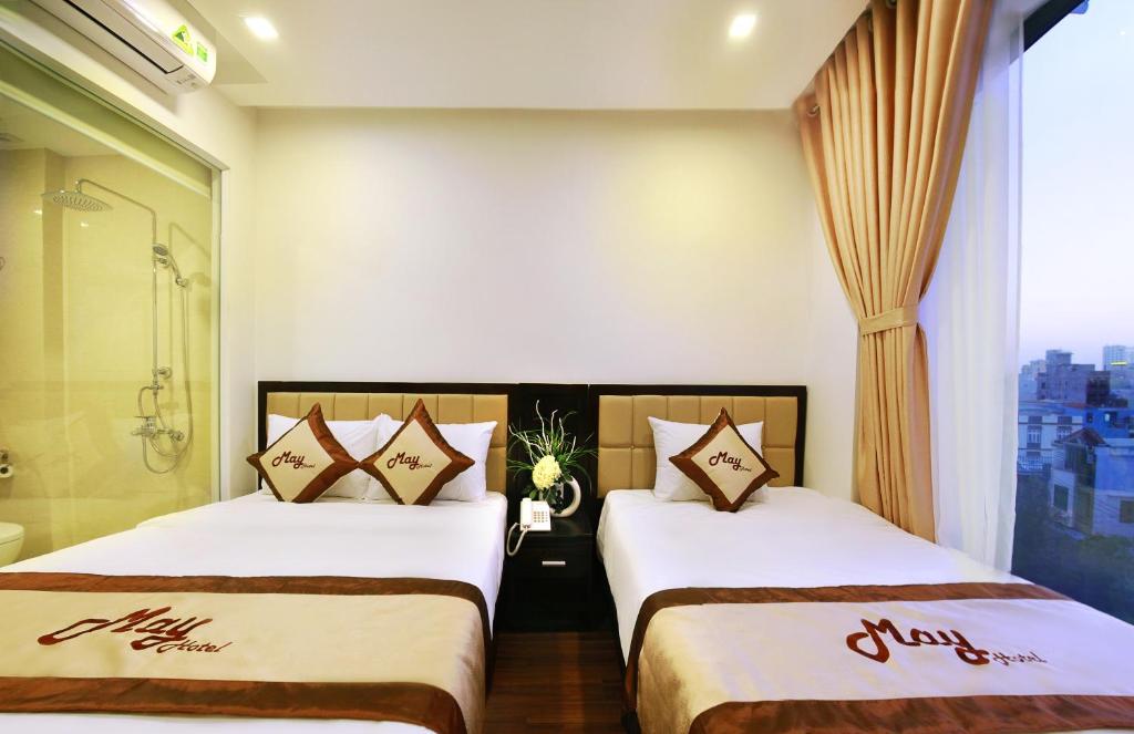 Postel nebo postele na pokoji v ubytování May Hotel