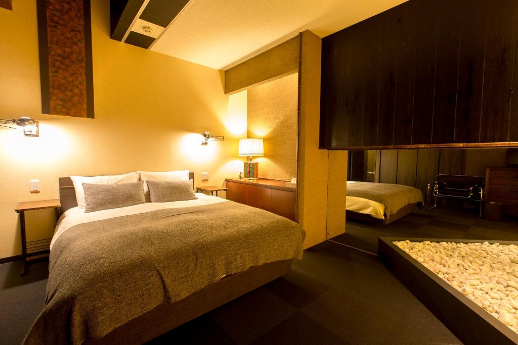 Postel nebo postele na pokoji v ubytování R&Run Kyoto Serviced Apartment & Suites