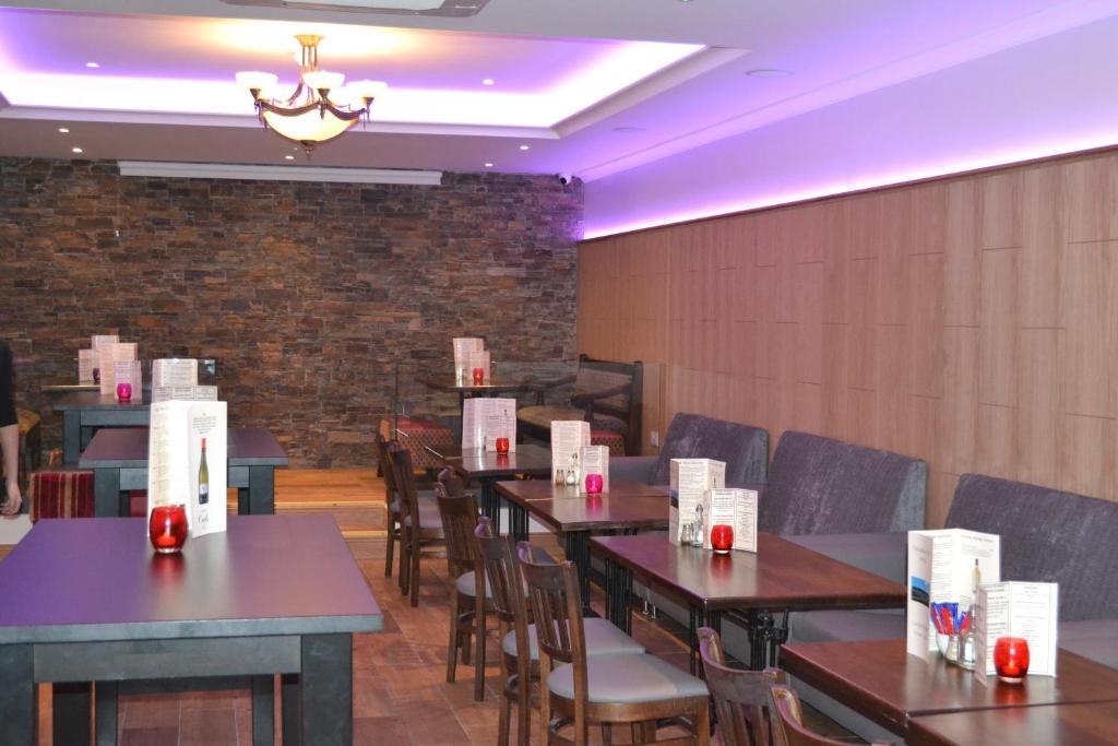 a dining room with tables and chairs with boxes on them at Caisleain Oir Hotel in Annagry