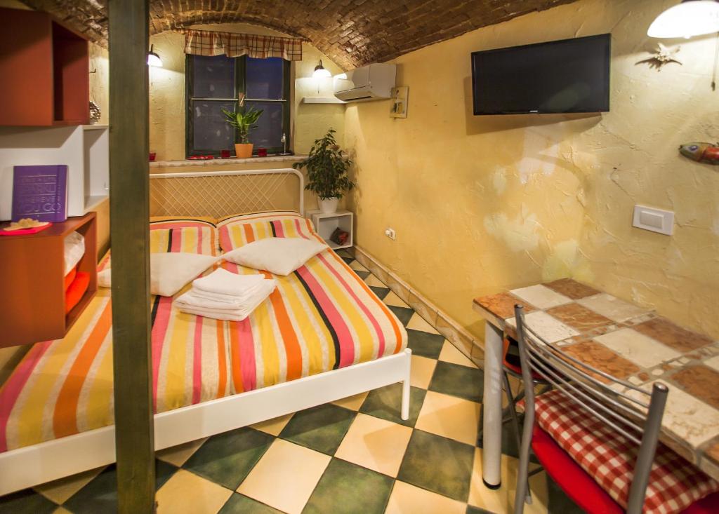a bedroom with two beds and a tiled floor at Cosy Little Love Nest in Piran in Piran