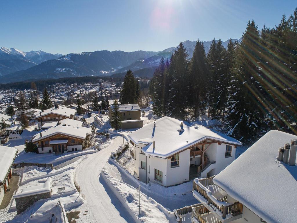 arial view of a snow covered village with houses at Edelweiss Bellavita in Flims