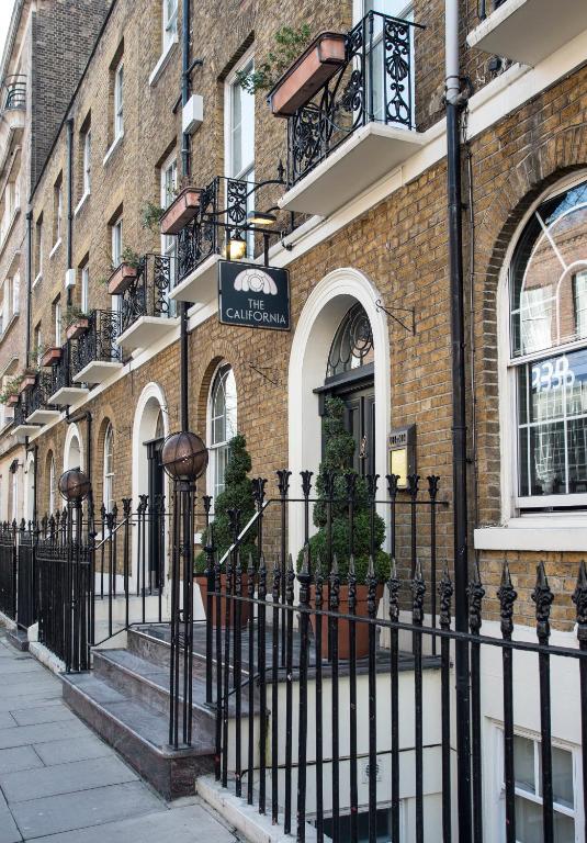 a black fence in front of a building at The California - London Kings Cross in London