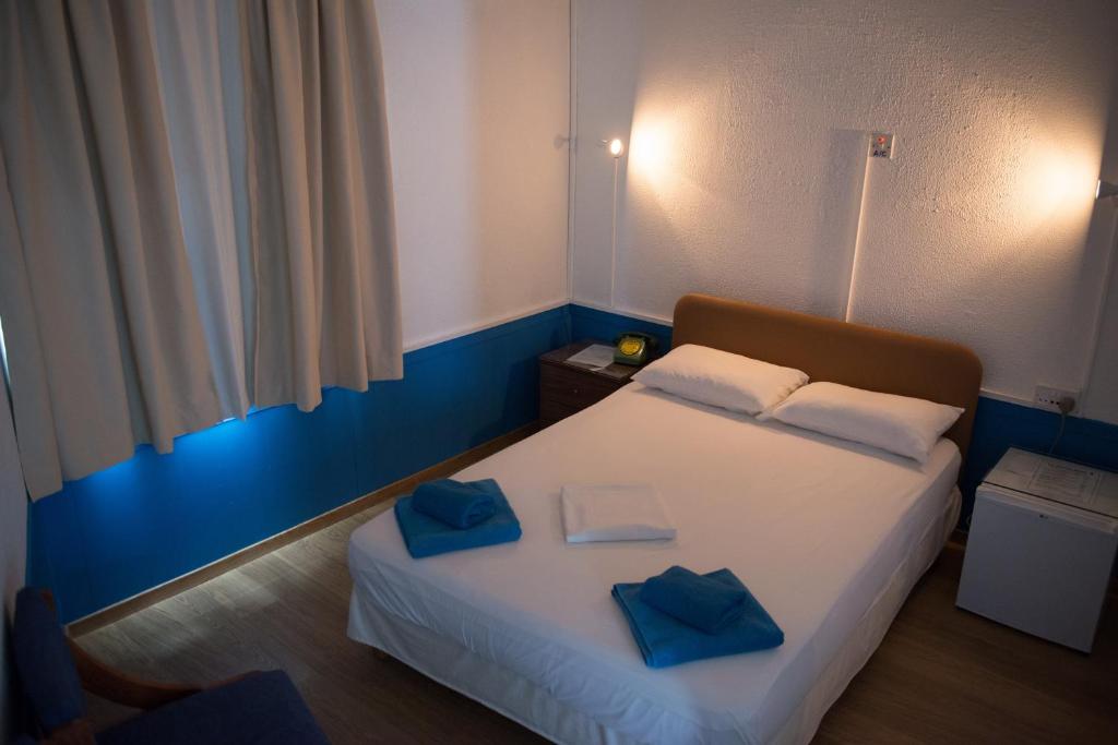 Postel nebo postele na pokoji v ubytování Le Village Hotel