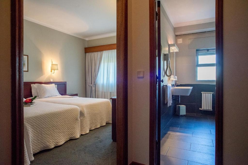 Postel nebo postele na pokoji v ubytování Hotel Boavista II