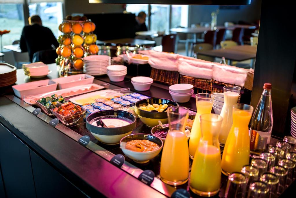 a buffet of food and drinks on a table at Campanile Toulouse Sesquieres in Toulouse